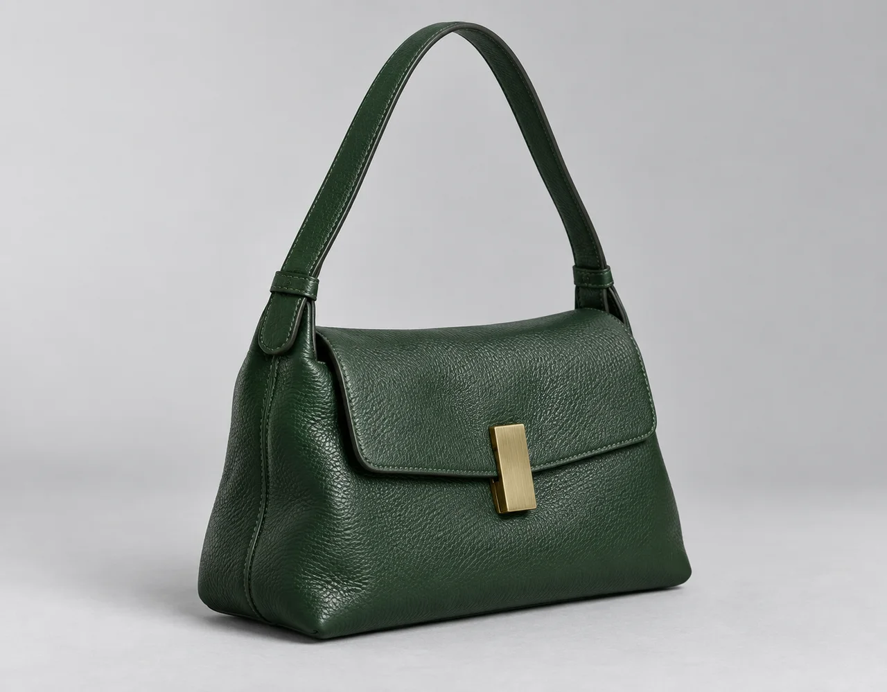 Forest-green leather shoulder handbag with grained texture and brass closure